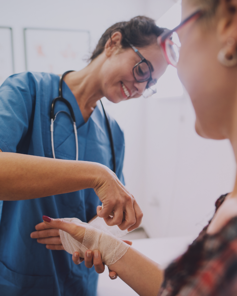 Picture of a doctor attending the wounds of her patient