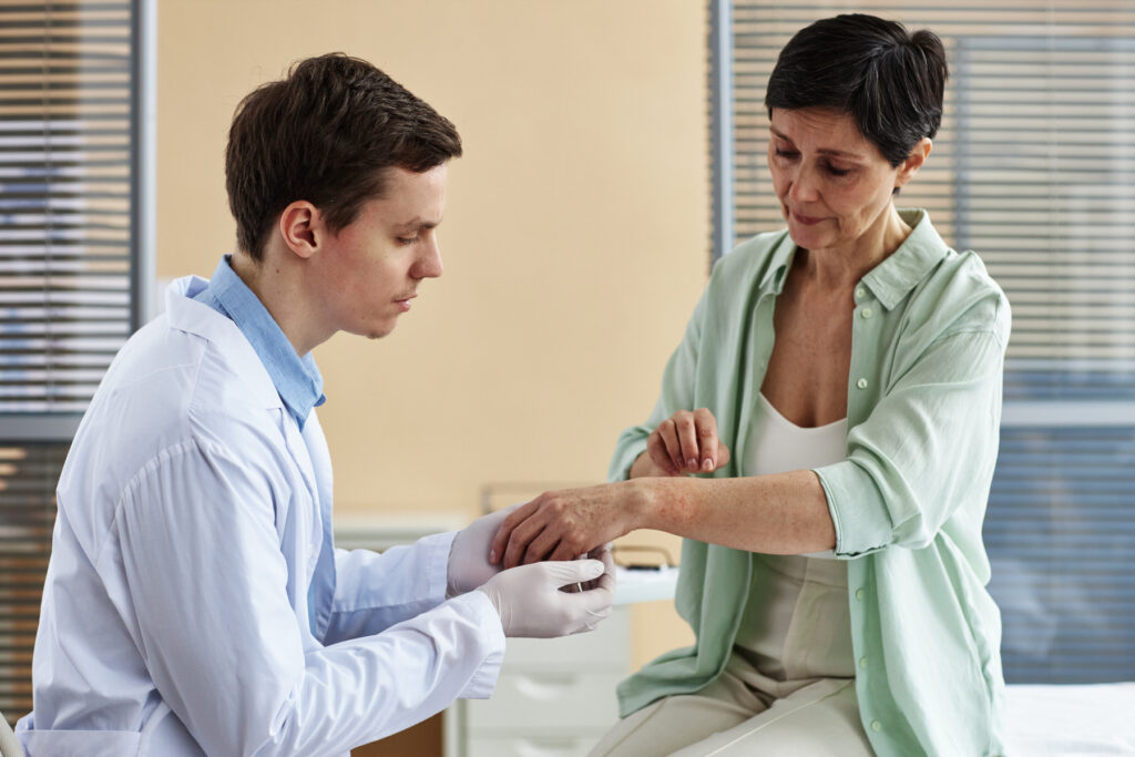 Picture of a doctor examining the patient arms