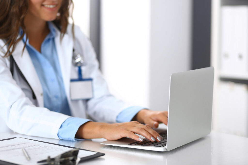 Picture of a doctor woman typing on her laptop