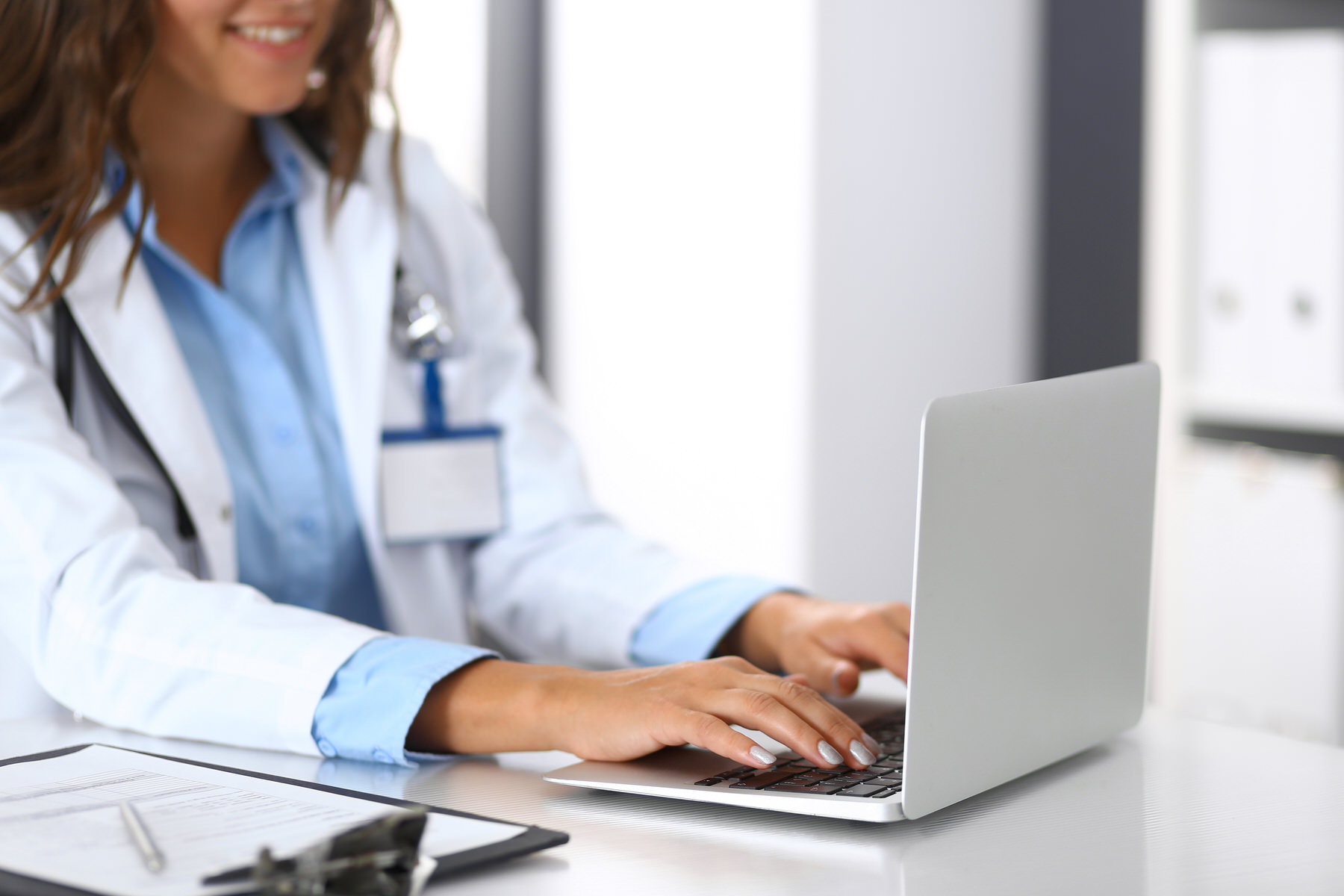 Picture of a doctor woman typing on her laptop