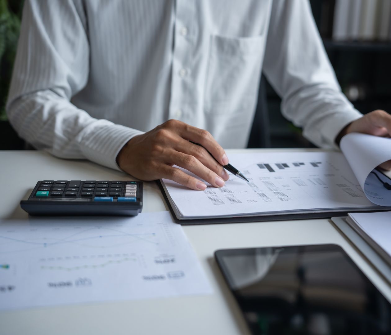 Picture of a hands of a man working on a report